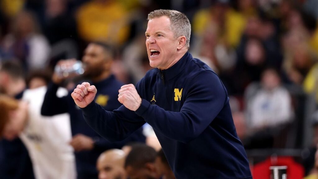Michigan Wolverines head coach Dusty May directing his players on the basketball court