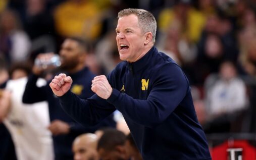 Michigan Wolverines head coach Dusty May directing his players on the basketball court