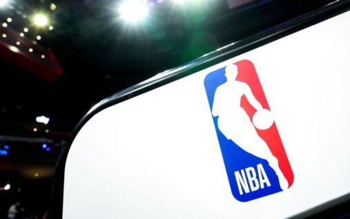 A packed basketball arena showing thousands of fans watching an NBA game