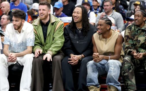 Shai Gilgeous-Alexander and Nikola Jokic sitting on the bench during an NBA game