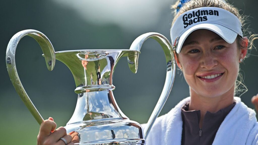 Nelly Korda celebrating with the trophy after winning the Chevron Championship