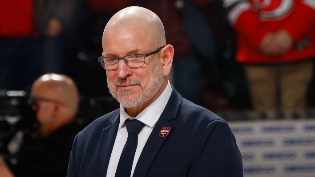 Tom Fitzgerald looking on from the stands during a New Jersey Devils NHL game