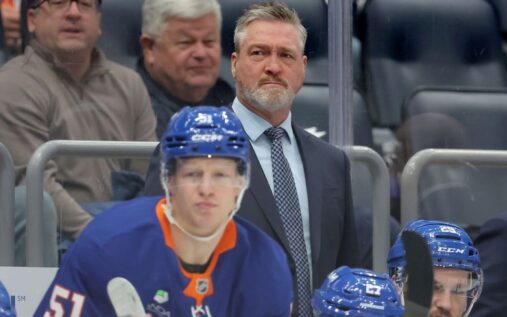 Peter DeBoer looking on from the bench during an NHL ice hockey match