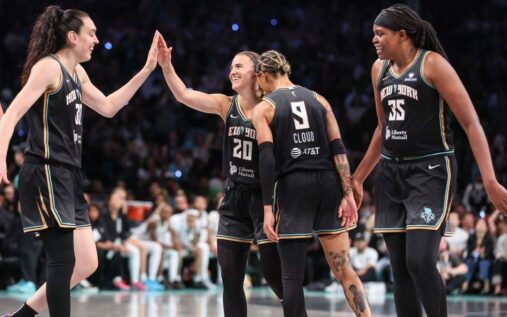 Breanna Stewart, Sabrina Ionescu, and Jonquel Jones celebrating together in New York Liberty uniforms