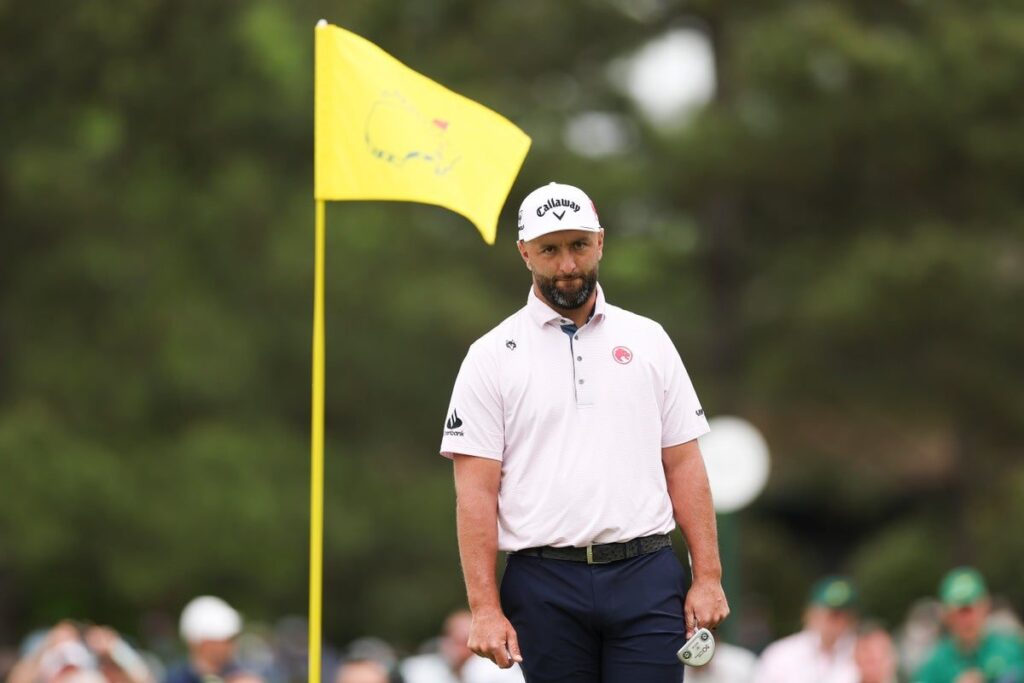 Nick Faldo and Jon Rahm looking on during a professional golf tournament