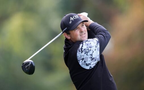 Patrick Reed speaking at a Masters press conference wearing a golf polo