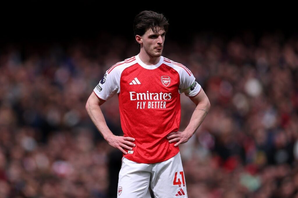 Declan Rice driving forward with the ball in midfield for Arsenal