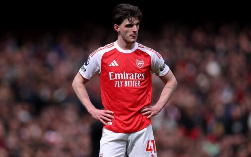 Declan Rice driving forward with the ball in midfield for Arsenal