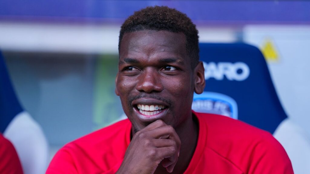 Paul Pogba wearing a Monaco jersey looking determined during a press conference