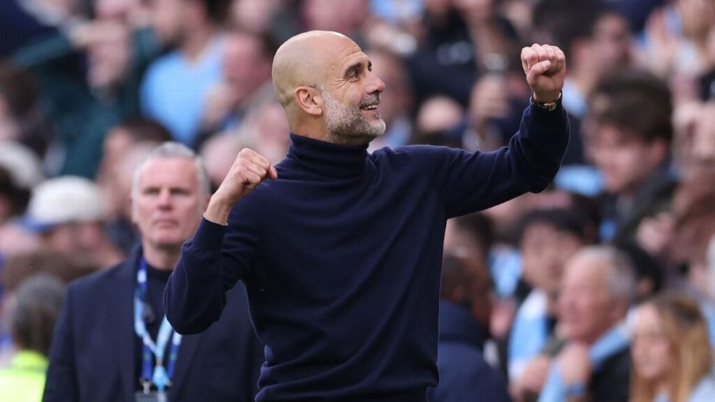 Pep Guardiola looking thoughtful on the touchline during a Manchester City Premier League match