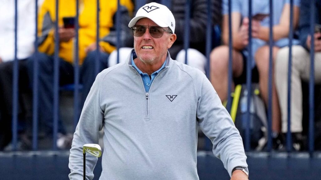 Phil Mickelson looking thoughtful on the golf course wearing his traditional cap and golf attire