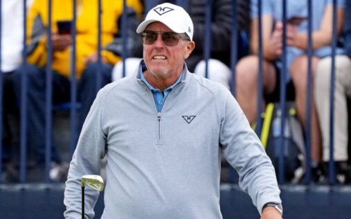 Phil Mickelson looking thoughtful on the golf course wearing his traditional cap and golf attire