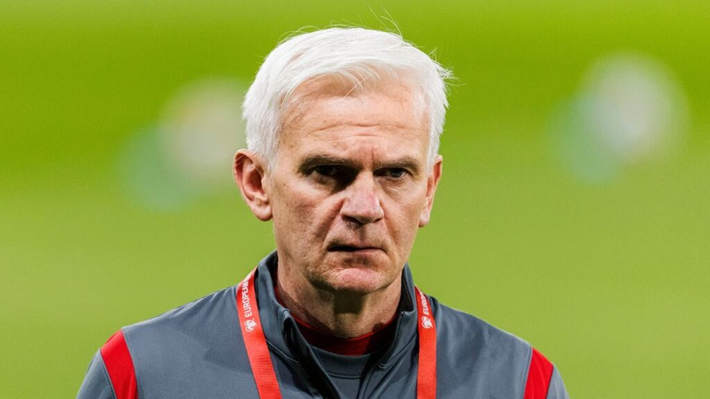Jacek Magiera standing on the touchline while managing the Poland national football team