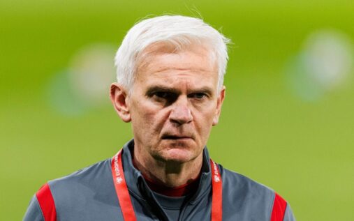 Jacek Magiera standing on the touchline while managing the Poland national football team