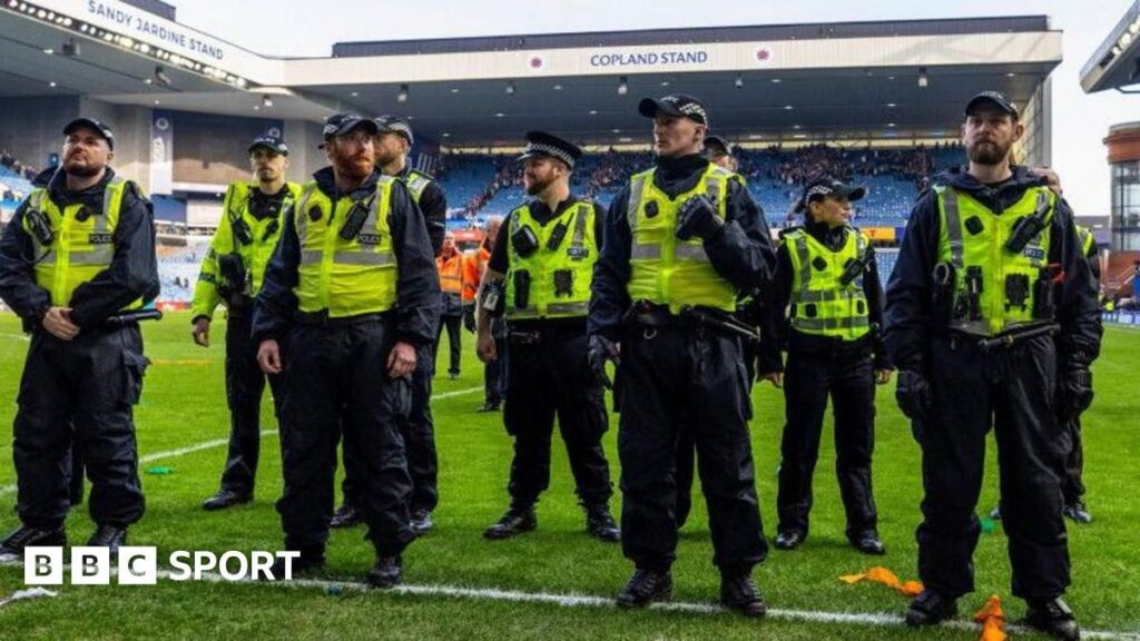 Rangers and Celtic players competing on the pitch during a tense Old Firm derby match