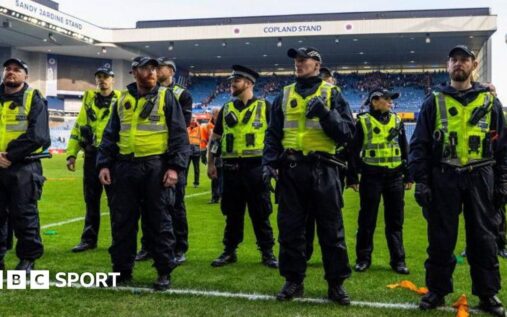 Rangers and Celtic players competing on the pitch during a tense Old Firm derby match