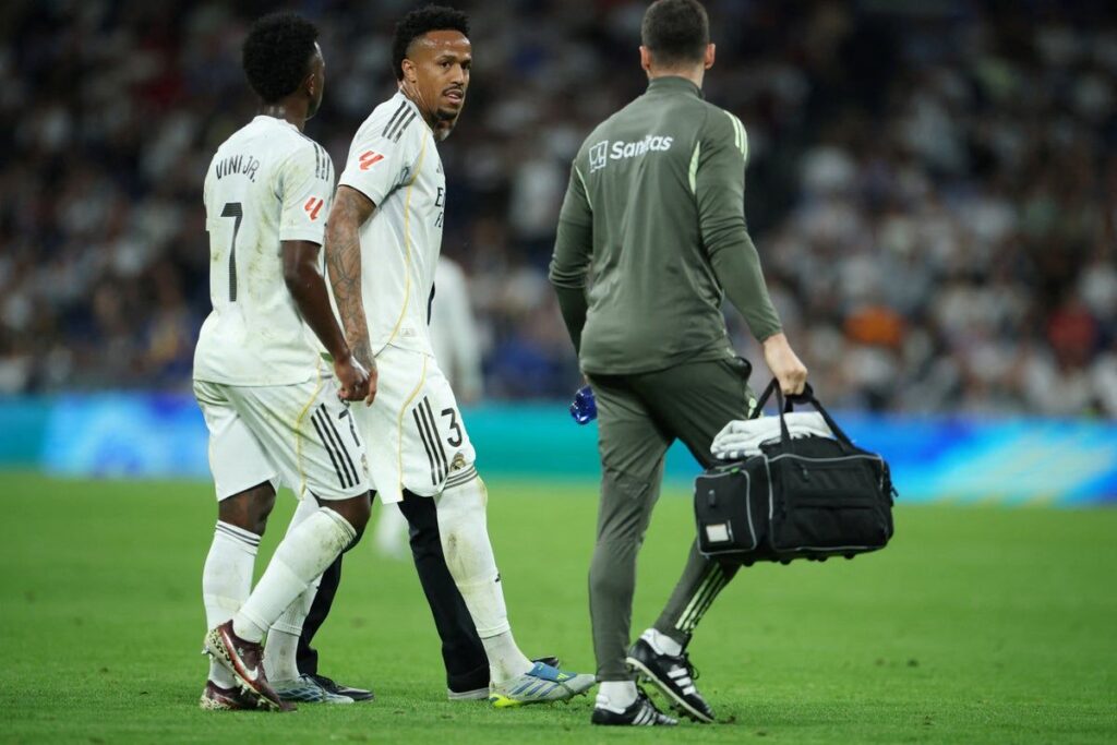 Eder Militao walking off the pitch looking dejected in a Real Madrid kit