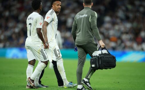 Eder Militao walking off the pitch looking dejected in a Real Madrid kit