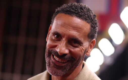 Rio Ferdinand speaking into a microphone while working as a television pundit