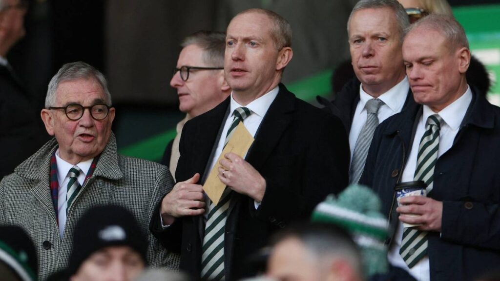 Robbie Keane standing on the touchline in a suit managing his team