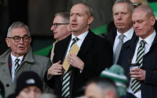 Robbie Keane standing on the touchline in a suit managing his team