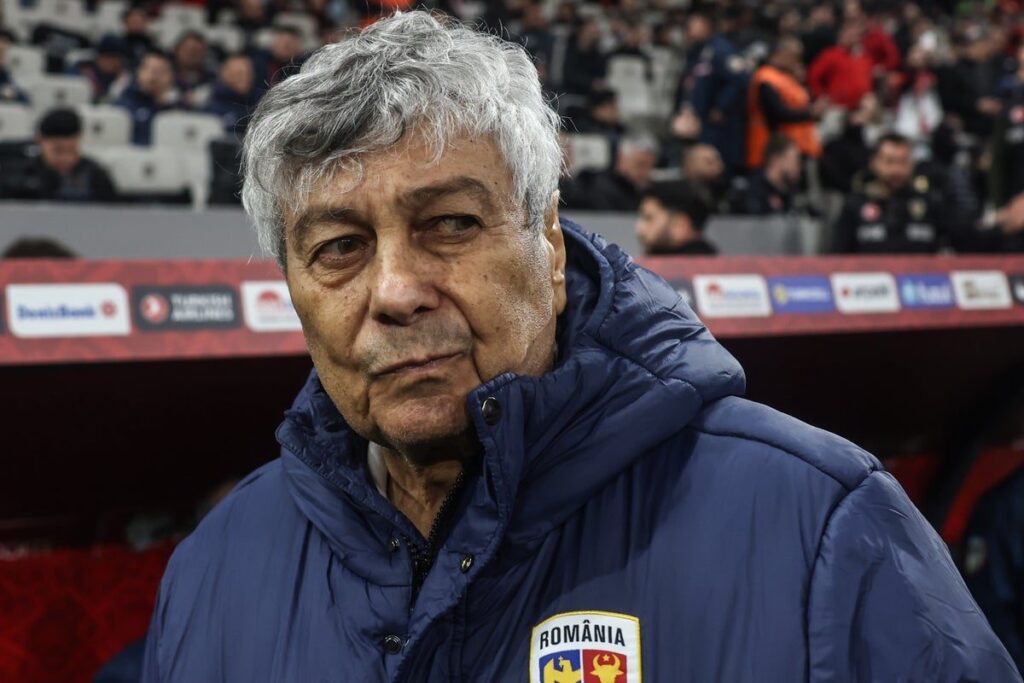 Mircea Lucescu standing on the touchline managing the Romanian national football team