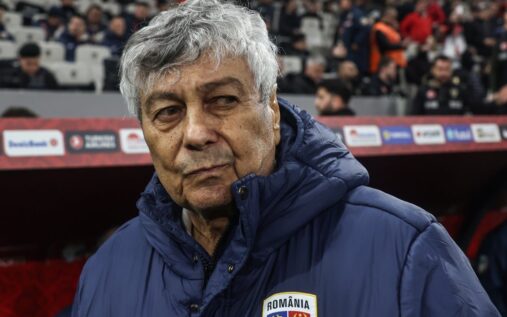 Mircea Lucescu standing on the touchline managing the Romanian national football team