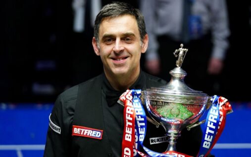 Ronnie O'Sullivan preparing to strike the cue ball during a snooker match