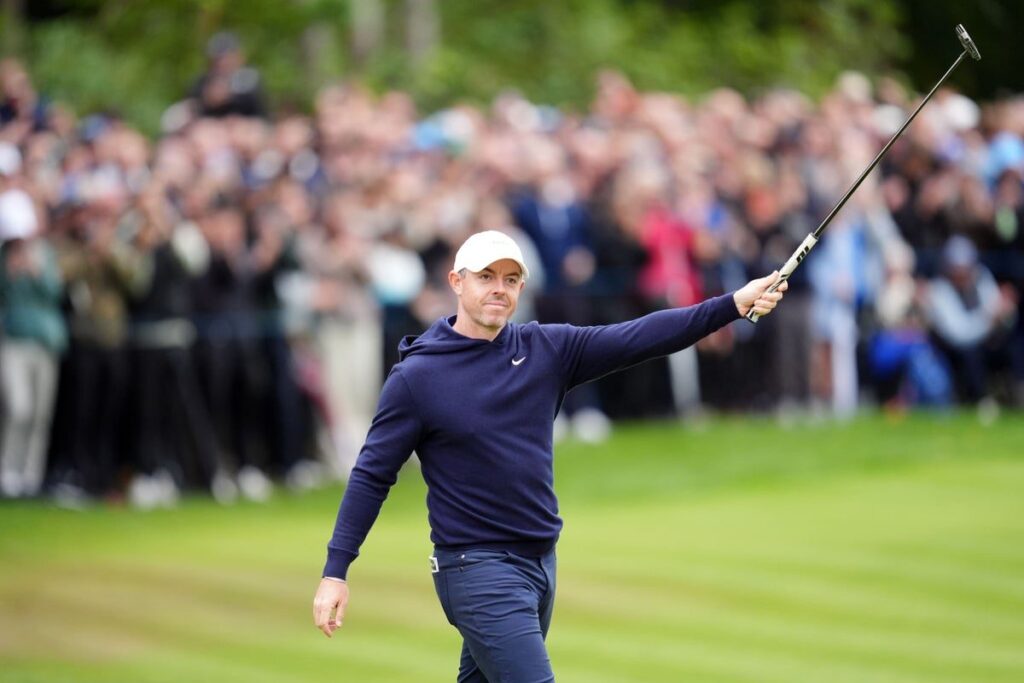 Defending US Masters champion Rory McIlroy lining up a putt on the green at Augusta National