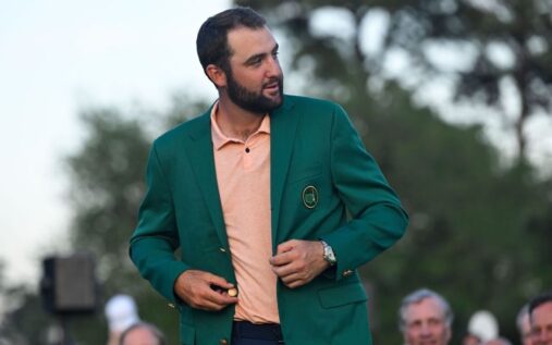 Scottie Scheffler walking at Augusta National Golf Club with his wife Meredith and newborn son Remy in a stroller
