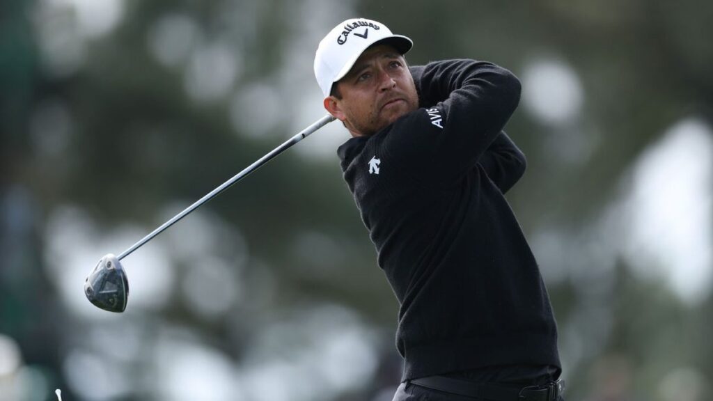 Scottie Scheffler swinging his golf club on the course at Augusta National