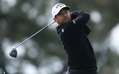 Scottie Scheffler swinging his golf club on the course at Augusta National