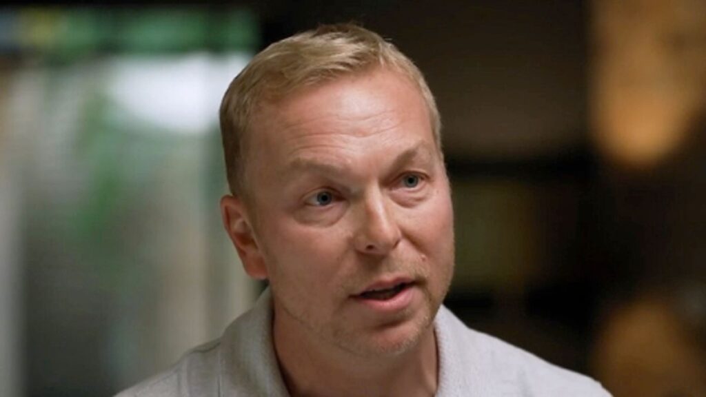 Sir Chris Hoy speaking at a microphone during a public event to raise awareness for prostate cancer screening