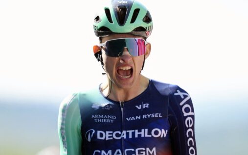 Tadej Pogacar and 19-year-old French cyclist Paul Seixas competing on a steep uphill climb during a professional road race.