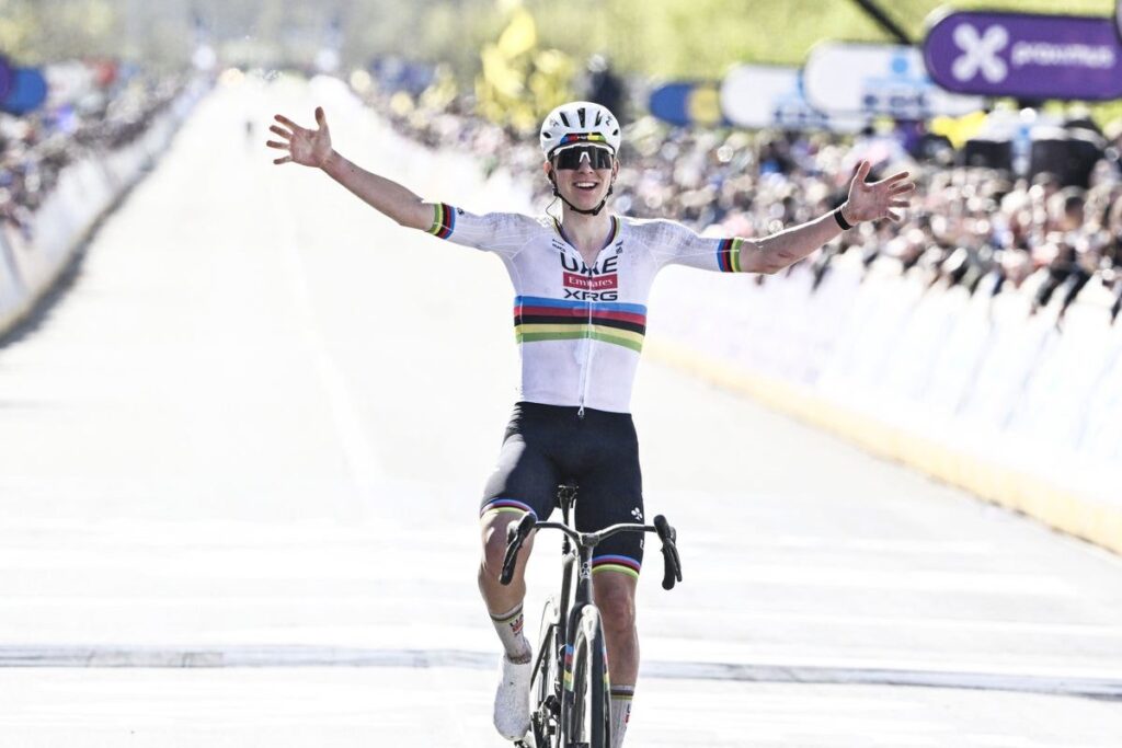 Tadej Pogacar celebrating as he crosses the finish line to win the Tour of Flanders