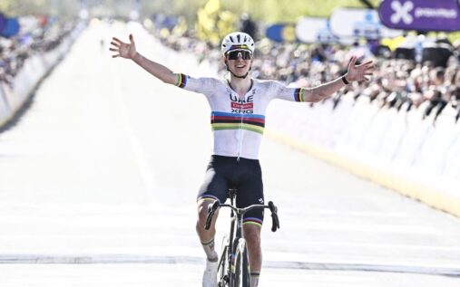 Tadej Pogacar celebrating as he crosses the finish line to win the Tour of Flanders