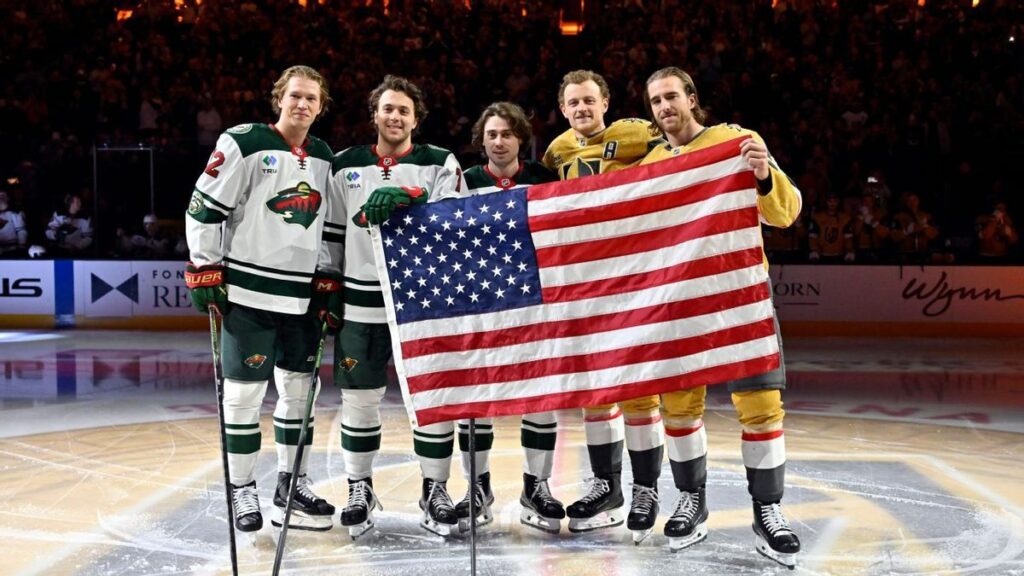 Team USA ice hockey players celebrating their Olympic gold medal victory on the ice