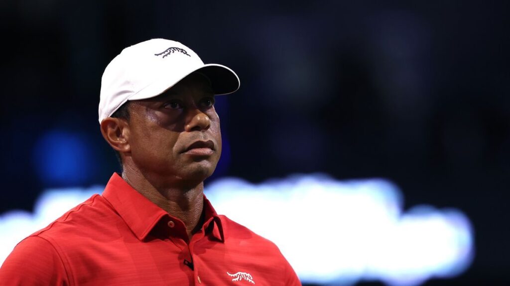 Tiger Woods looking serious while walking on a golf course
