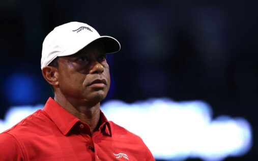 Tiger Woods looking serious while walking on a golf course