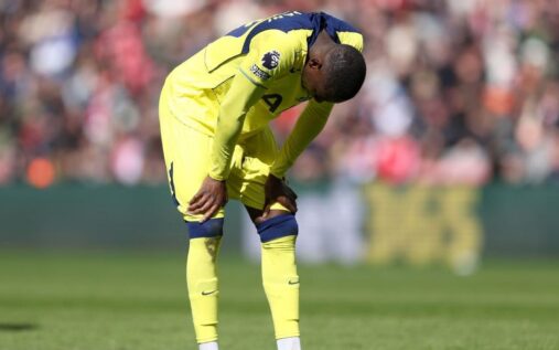 Dejected Tottenham Hotspur players standing on the pitch during a Premier League match