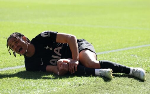 Tottenham Hotspur attacker Xavi Simons receiving medical treatment on the pitch after a severe knee injury