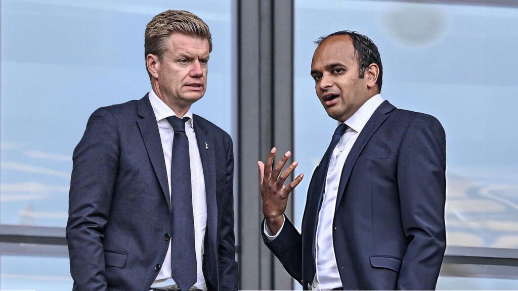 Ange Postecoglou standing on the touchline looking thoughtful during a Premier League football match