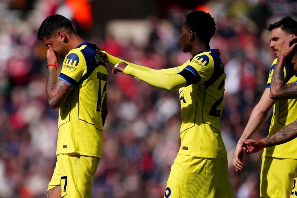 Tottenham Hotspur players looking dejected on the football pitch