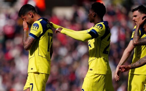 Tottenham Hotspur players looking dejected on the football pitch