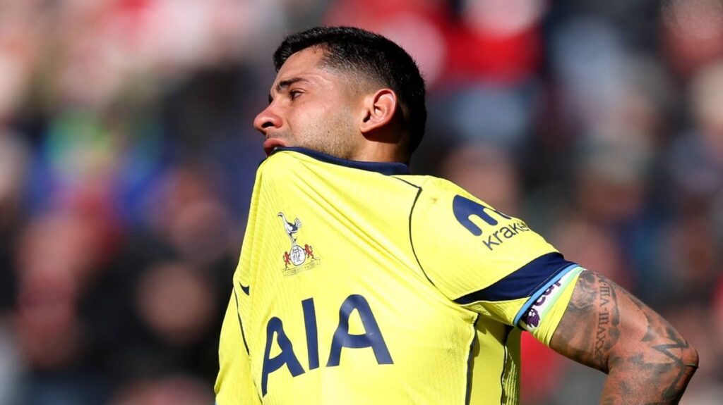 A dejected Tottenham Hotspur player looking down at the pitch during a Premier League match