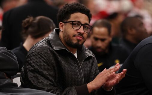 Tyrese Haliburton of the Indiana Pacers sitting on the bench wearing glasses