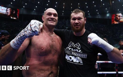 Tyson Fury standing victorious in the boxing ring after defeating Arslanbek Makhmudov