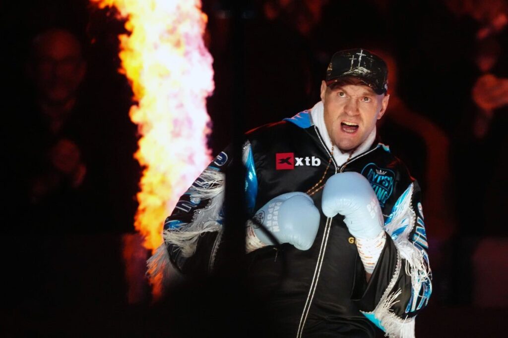 Tyson Fury celebrating in the boxing ring after defeating Arslanbek Makhmudov