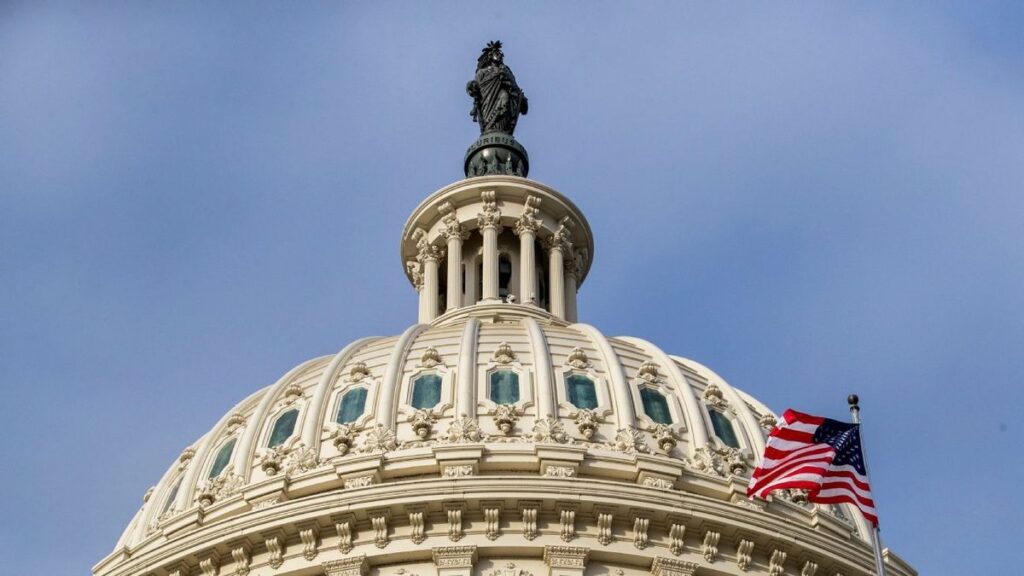 Senator Richard Blumenthal speaking at a podium alongside major US sports league logos
