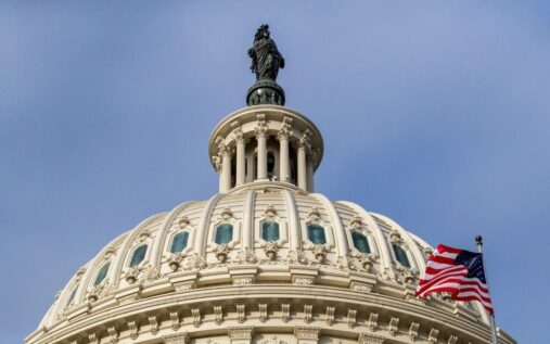 Senator Richard Blumenthal speaking at a podium alongside major US sports league logos